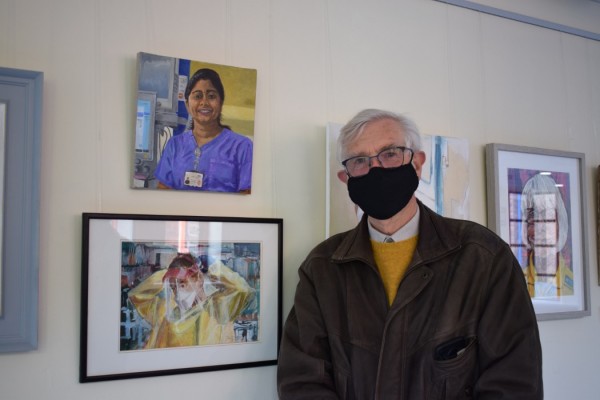 Artist Jo Field with portrait of Merlien Anna Kurien: ITU Nurse